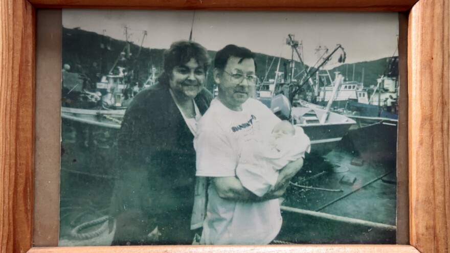 A photo of Thompson's grandparents holding her as a baby sits in the wheelhouse of her grandfather's fishing boat.