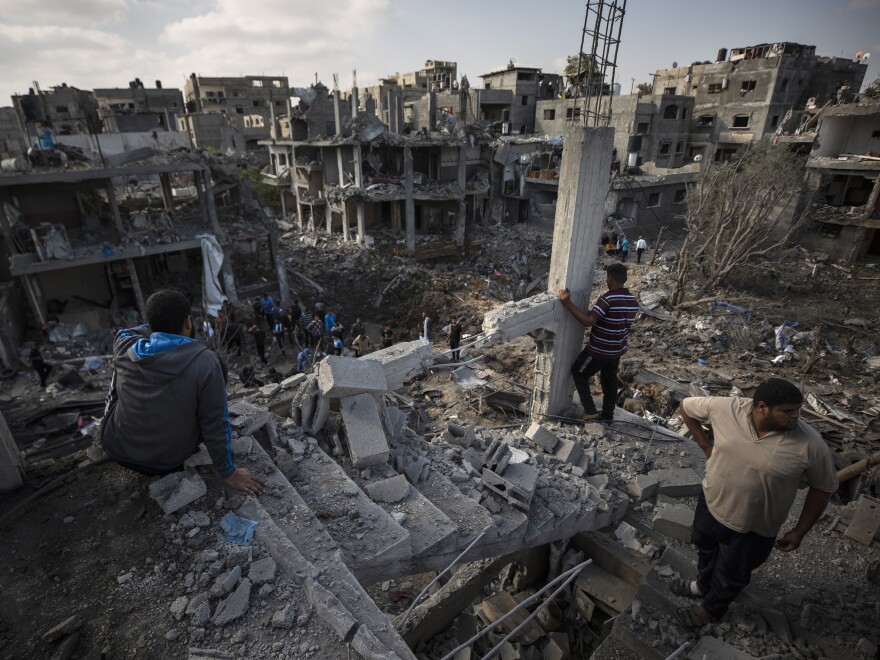 Palestinians inspect their destroyed houses following overnight Israeli airstrikes in the town of Beit Hanoun, northern Gaza Strip, on Friday.