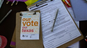Voter registration applications are seen at the Texas Rising tent during a Pride celebration in Corpus Christi, Texas, on Oct. 5, 2024.