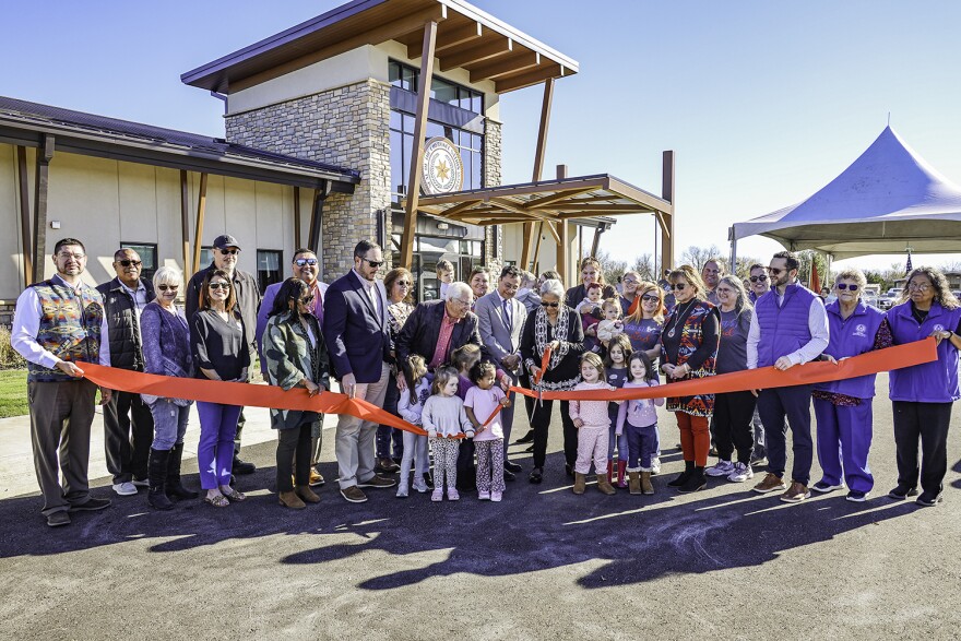 Members of the Cherokee Nation cut a ribbon in front of a newly constructed early childhood center in Nowata on Nov. 19, 2024.