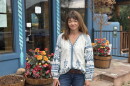 Woman stands outside.