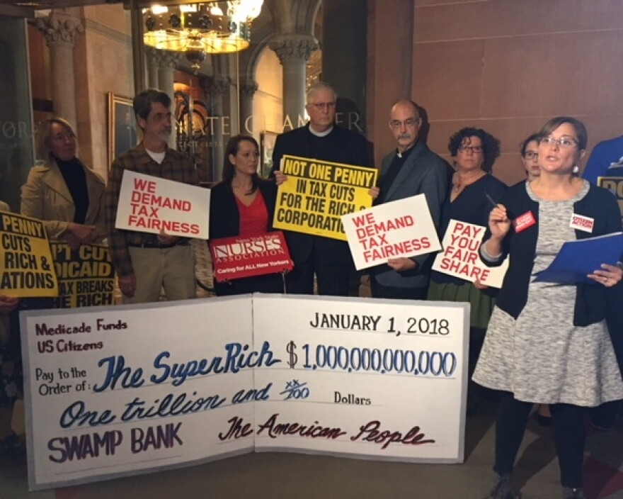 Jessica Wisneseki of Citizen Action speaks out against the House tax bill at a protest at the state Capitol on Thursday.