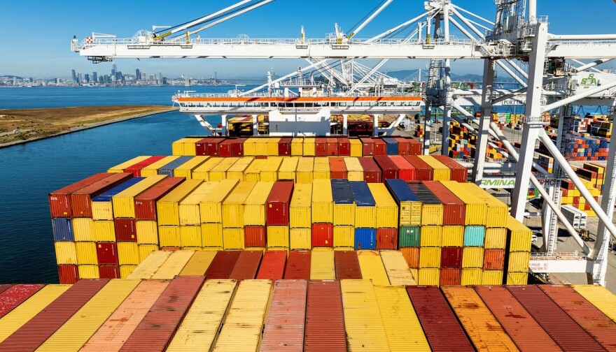 Cargo containers line a ship at the Port of Oakland on Wednesday, Aug. 6, 2025, in Oakland, Calif.
