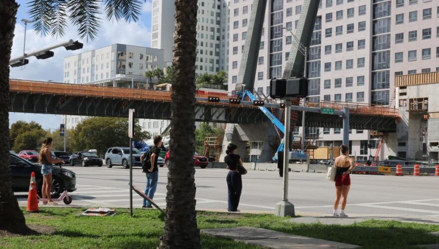 Pedestrians wait to cross Southwest Eighth Street. Johane Saintil