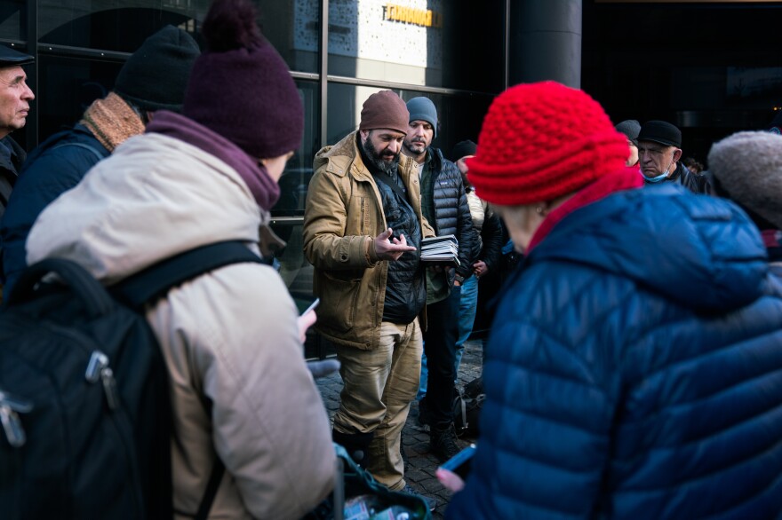 Stern sorts passports of some of the people he's helping to evacuate from Ukraine.