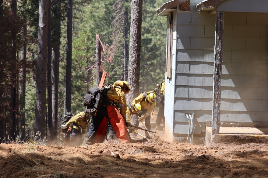 Firefighters clear damage during the Park Fire on July 30, 2024.