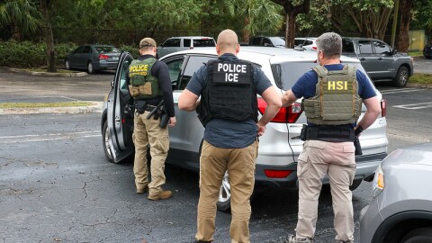 federal officials outside a car  