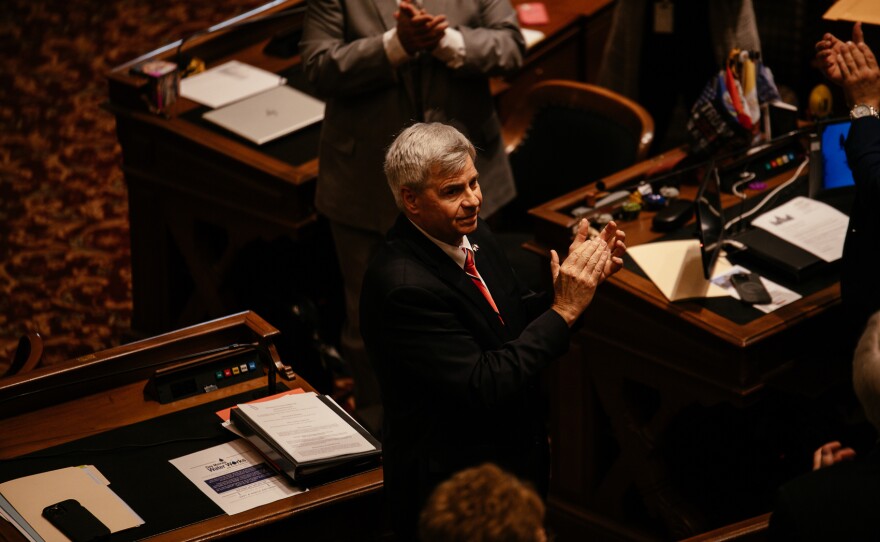 Sen. Dave Rowley claps on the floor at the Iowa Capitol.