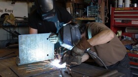 Taylor Atchison (L) and Antonio Knoy (R) work in their shop, Knoy Metalworks, in the old Fenpro building in Ballard. They're one of many workshop owners who will be displaced when the building is torn down.