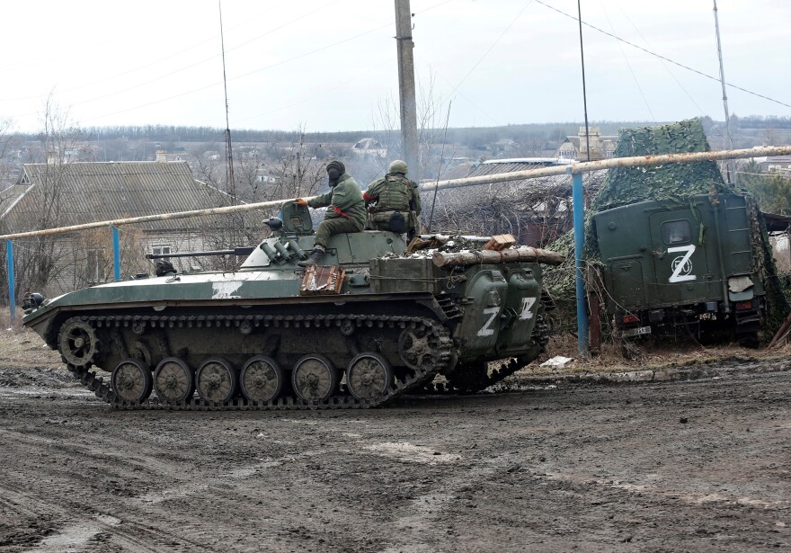 Service members of pro-Russian troops in uniforms without insignia drive an armoured vehicle with the symbol "Z" painted on its side in the separatist-controlled village of Bugas during Ukraine-Russia conflict in the Donetsk region, Ukraine on Sunday.