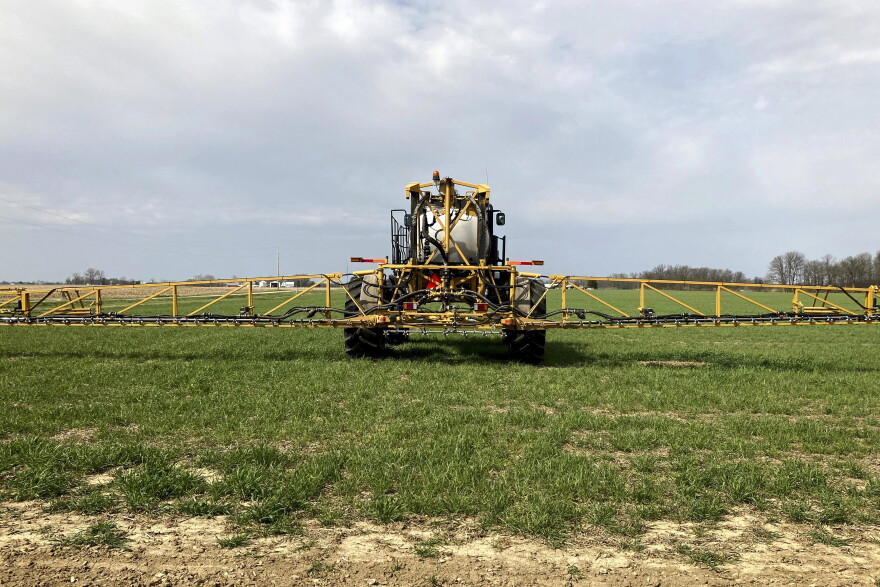 FILE - In this April 5, 2021 file photo, farmer Rick Clifton drives a spray tractor across one of his fields, applying herbicide to cover crops that occupied the ground during fall and winter in Orient, Ohio.