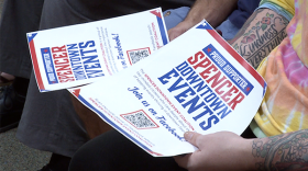 Residents hold Spencer Downtown Event Coalition flyers during the Sept. 9 meeting of the Owen County Commissioners