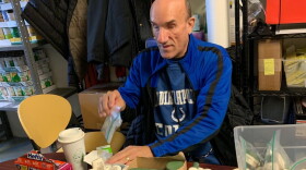 Sam McHenry packs bags at the Damien Center food pantry in Indianapolis.