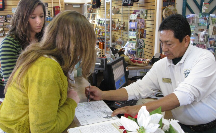 John Armijo shows visitors where to find the best trees.