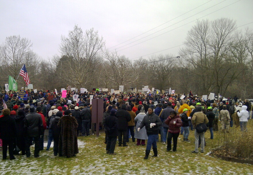 Protesters gather outside the gated community where Governor Snyder lives.