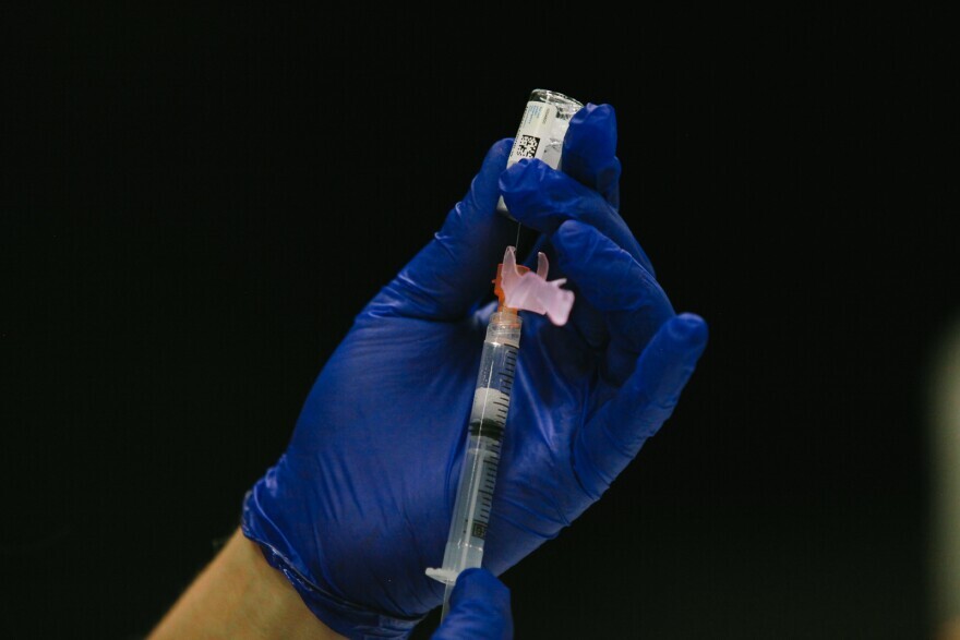 A vaccinator prepares a dose of the Johnson & Johnson COVID-19 vaccine at a vaccination clinic at Cypress Bayou Casino. April 7, 2021.