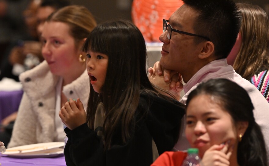 Sophia Chen, 6, listens to rules for a game using chopsticks to move popcorn during a Lunar New Year celebration at the University of Scranton.
