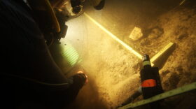 In this 2015 photo provided by Texas A&M's Center for the Study of the First Americans, divers investigate the Page-Ladson archaeological site in Florida. Scientists say artifacts found deep underwater in a Florida sinkhole show people lived in that area some 14,500 years ago. That makes it the earliest well-documented site for human presence in the southeastern U.S., and important for understanding the settling of the Americas, experts said. (S. Joy/CSFA via AP)