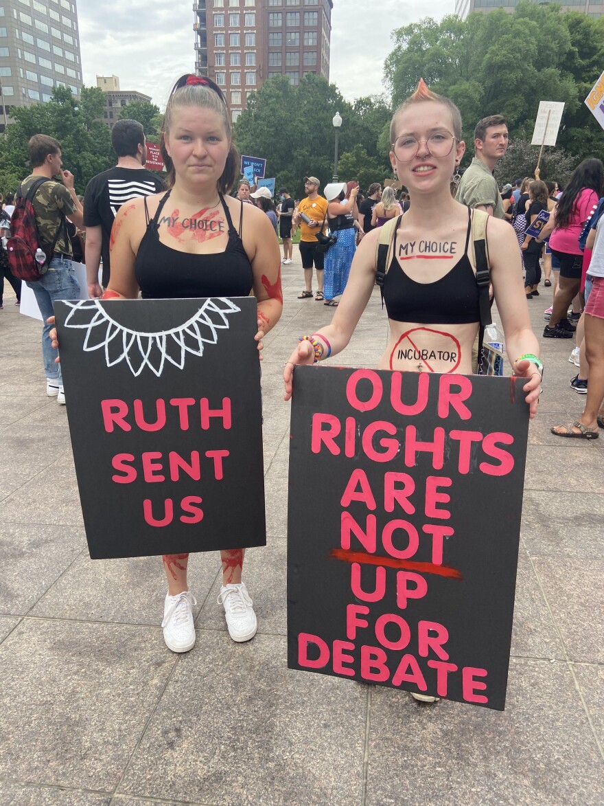 Women hold signs at abortion rights rally at the Ohio Statehouse on June 26, 2022