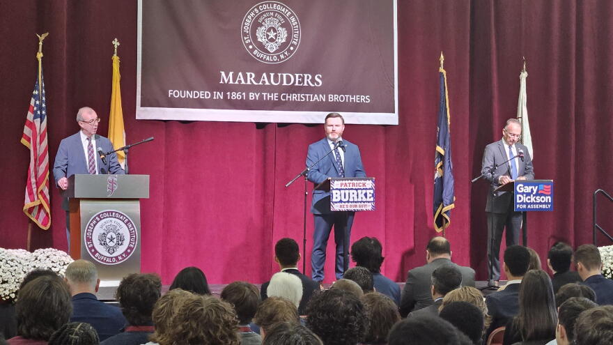 Democratic State Assemblymember Pat Burke, center, and Republican challenger Gary Dickson, right, make their opening statements during a debate at St. Joseph's Collegiate Institute.