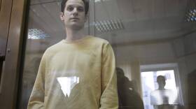 Wall Street Journal reporter Evan Gershkovich stands in a glass cage in a courtroom at the Moscow City Court. (Dmitry Serebryakov/AP)