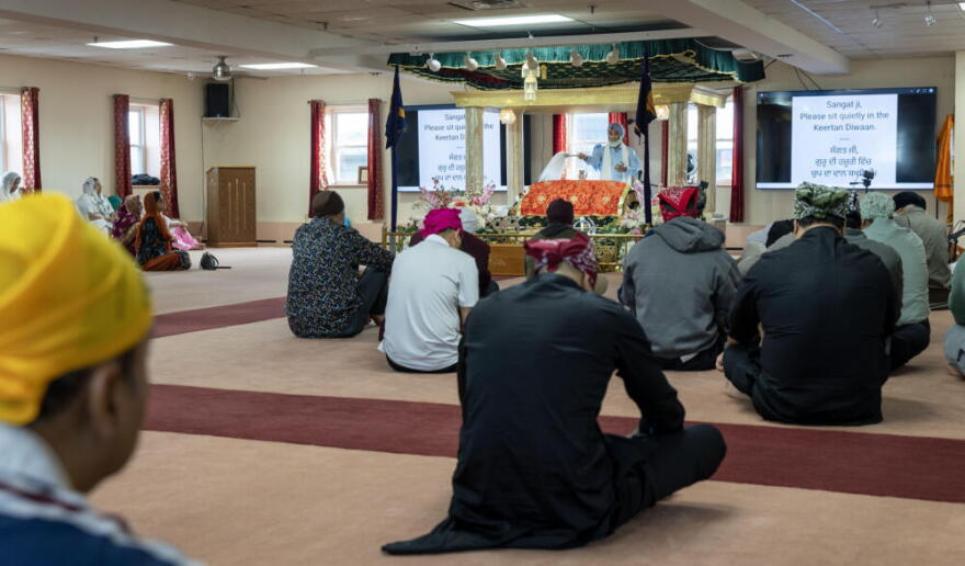 Congregants sit at a prayer service at the Gurdwara Guru Nanak Darbar in Medford, Mass.  (Robin Lubbock/WBUR)