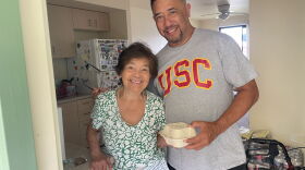 Damian Loo stands with a Kauaʻi resident after delivering a hot meal to her after Hurricane Lowell hit earlier this month.