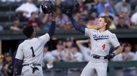 Connecticut's Korey Morton (4) celebrates with Bryan Padilla (1) after hitting a two-run home run against Stanford during the second inning of an NCAA college baseball tournament super regional game Saturday, June 11, 2022, in Stanford, Calif.