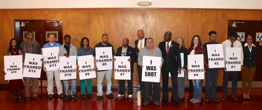 Attorneys Benjamin Crump (speaking) and Mike Laux speak with participants before Tuesday's press conference about no-knock raids.