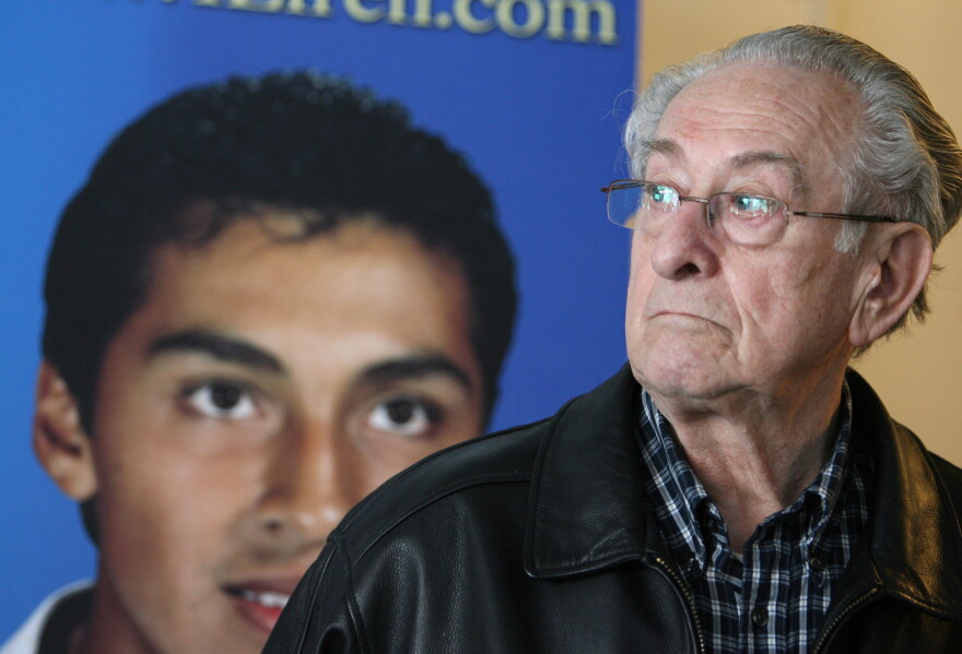 Hans Koppenhoefer stands by a photo of his son at age 15, Efren Paredes, Jr., before a news conference Wednesday, Dec. 3, 2008, in Lansing, Mich. At the time, Paredes and his family were pursuing clemency from then - Governor Jennifer Granholm. Koppenhoefer passed away in 2022.