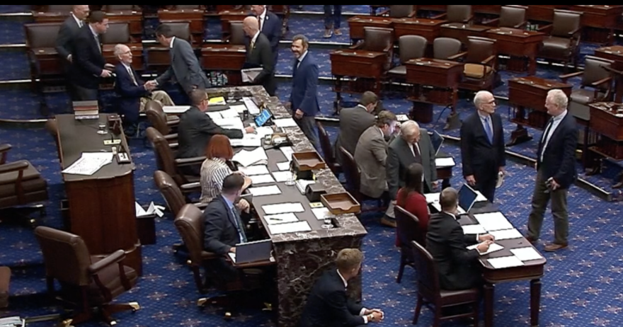 Sen. Mitch McConnell, wheeled out in a wheelchair, casts his first roll call vote since he was hospitalized after a fall in June.