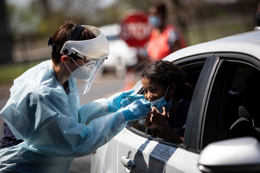 Lena Froese administers a nasal swab test to Sarohyth Maldonado at a post-spring break COVID-19 testing event at the Austin ISD headquarters on March 26. 