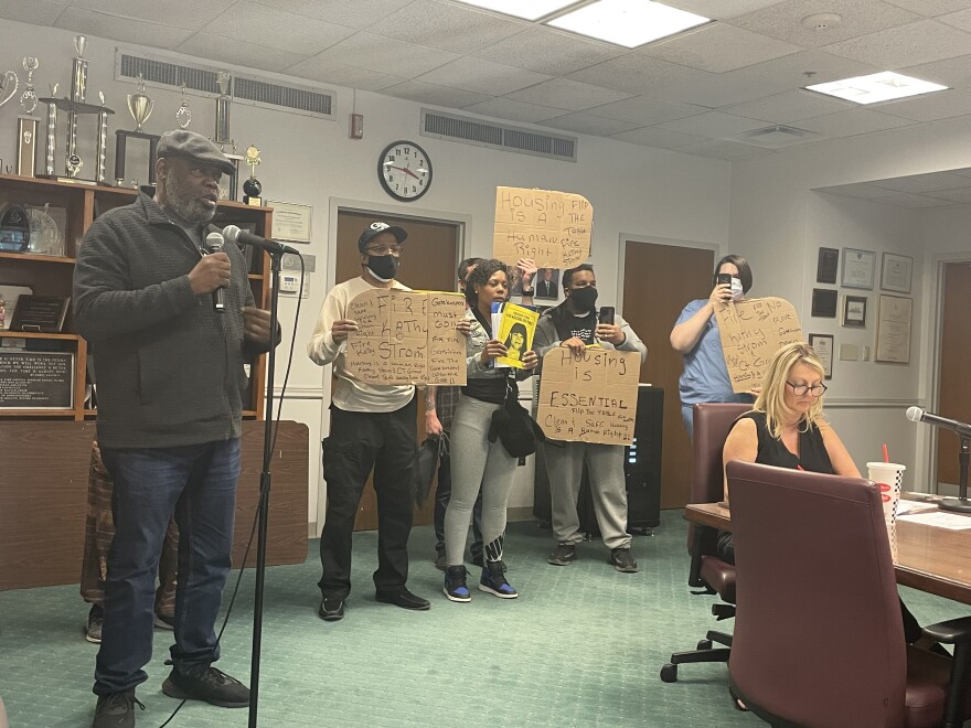 Richard Faulkner and other residents of Louisville Metro Housing Authority properties protesting before the agency's board.