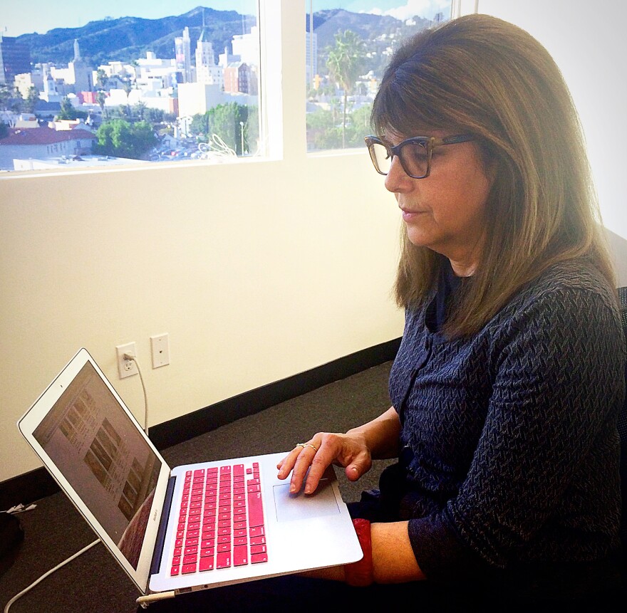 Margie Simkin works in her office on Sunset Blvd., overlooking the iconic Hollywood landscape.