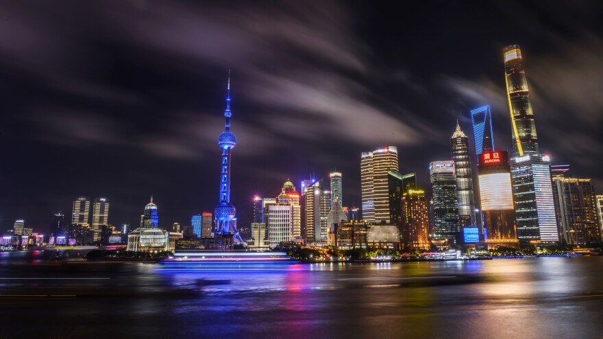 SHANGHAI, CHINA - AUGUST 29: Boats travel on the Huangpu River as the skyline of the city in the Pudong district is seen on August 29, 2020 in Shanghai, China.