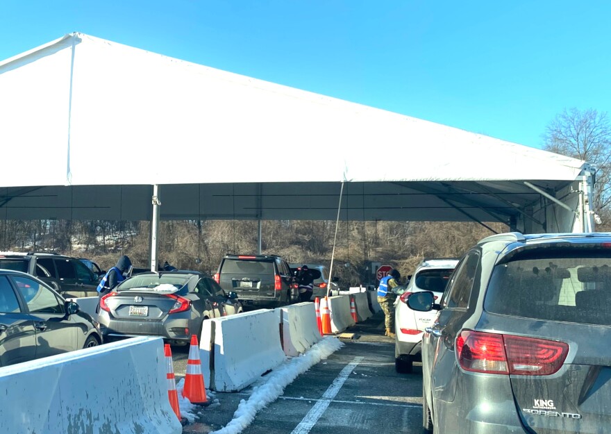 At The Six Flags drive-thru mass vax site in Bowie, Maryland in mid-March, residents in their cars line up for their COVID-19 shots.