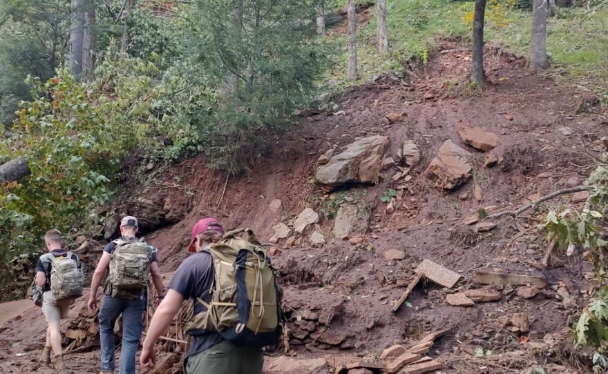 A team of volunteers hikes to reach community members up impassable roads.