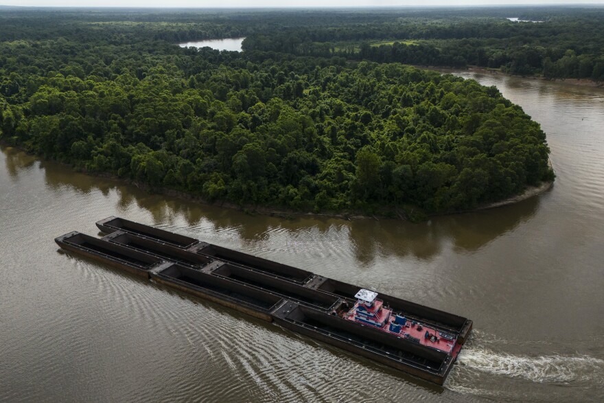 A ship pushes barges on the Tombigbee River near the top of the Mobile–Tensaw Delta on Wednesday, June 5, 2024, near McIntosh, Ala. (AP Photo/Mike Stewart)