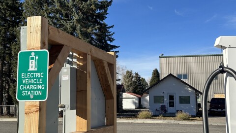 A green sign that says, "Electric Vehicle Charging Station."