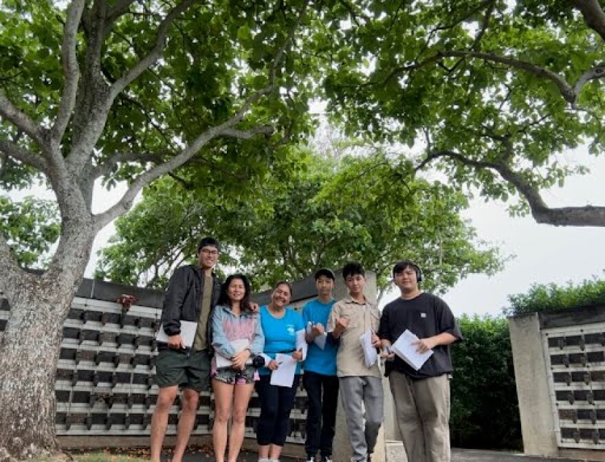 Sage Tottori (second to right) and his friends and family have been working to geotag every nisei veteran gravesite at the National Memorial Cemetery of the Pacific in Punchbowl.