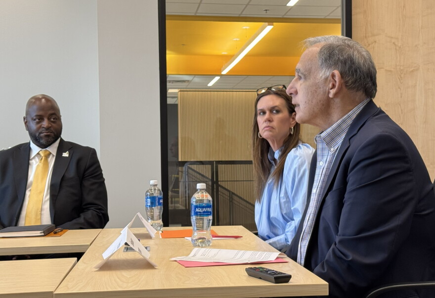 Sen. John Boozman (right) and Gov. Sarah Huckabee Sanders (middle) speak with catfish farmers and aquaculture experts at the University of Arkansas at Pine Bluff, as the school's Chancellor Anthony Graham (left) listens.