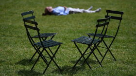 A man takes a nap on the Bryant Park Lawn in midtown New York City.