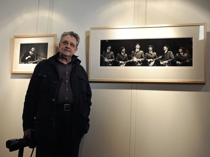 Photographer Mike Mitchell poses with his photographs of the first U.S. performance of The Beatles at the Washington Coliseum<em></em> in central London in 2011.
