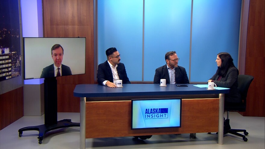 A television host interviews guests.