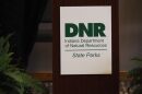 A Department of Natural Resources sign hangs on a lectern in The Garrison Conference Center at Fort Harrison State Park in Indianapolis, Indiana, on Tuesday, March 17, 2026.