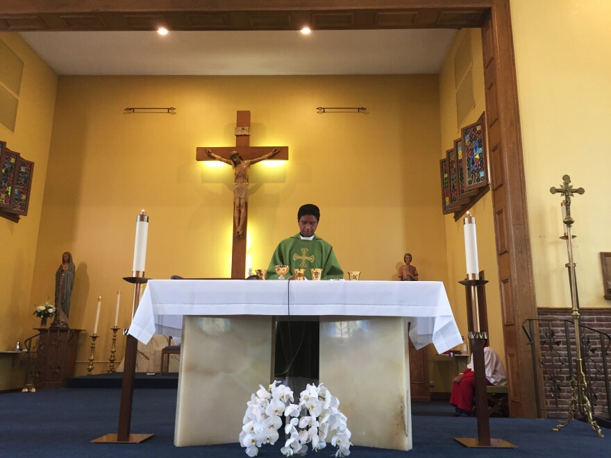 The Rev. Matthew Nathan celebrates a Spanish-language Mass at St. Alexis.