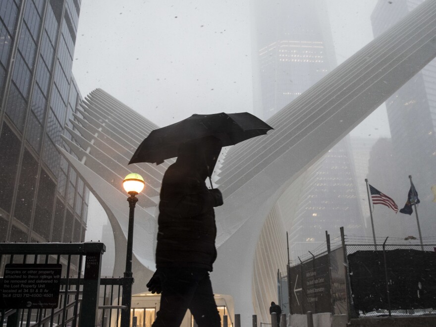A man walks through snow during the morning commute in Manhattan on Tuesday.
