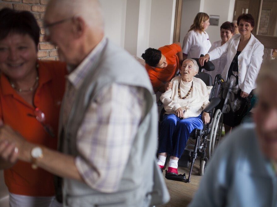 Sonja Miskulin (center), a former translator who suffers from dementia, celebrates her birthday at a nursing home in Szklarska Poreba, Poland, in August.