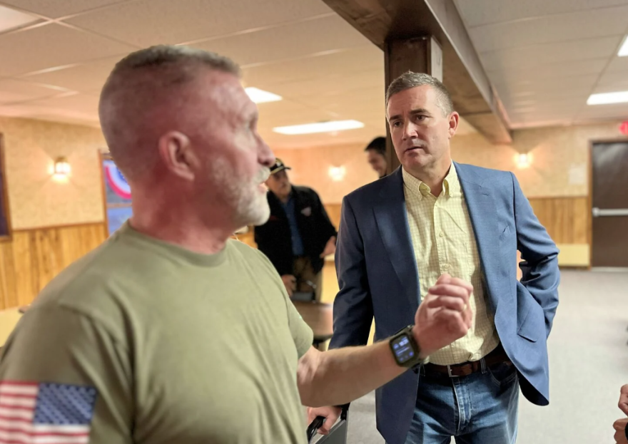 Blake Gendebien, right, speaking with Joe Fisher, an independent voter who attended Gendebien's recent event at the VFW in Saranac Lake.