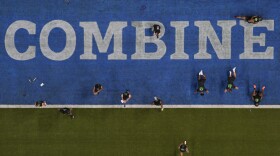 Offensive linemen stretch at the NFL football scouting combine, Sunday, March 2, 2025, in Indianapolis.  